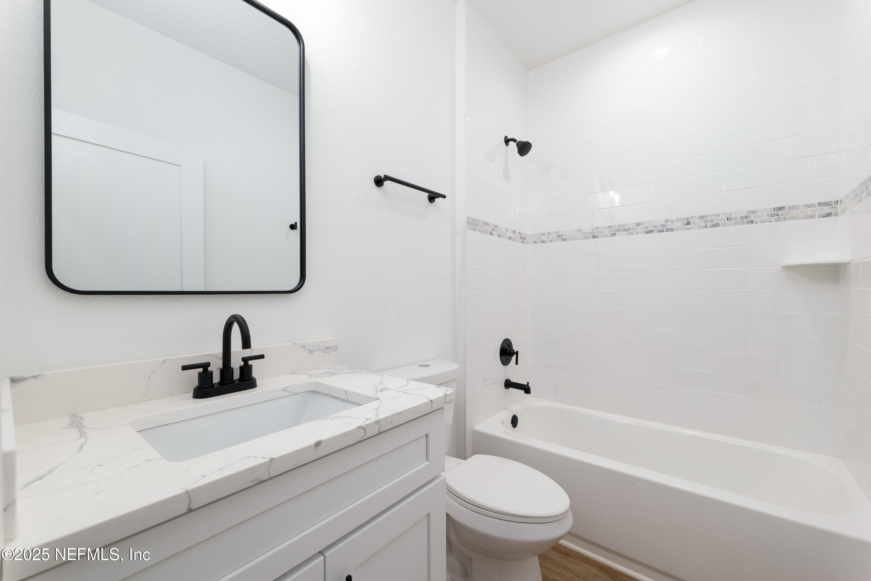 2482 Oleander Avenue Middleburg, FL 32068 - Photo 19 of 34 a bathroom with a sink a toilet and a bathtub