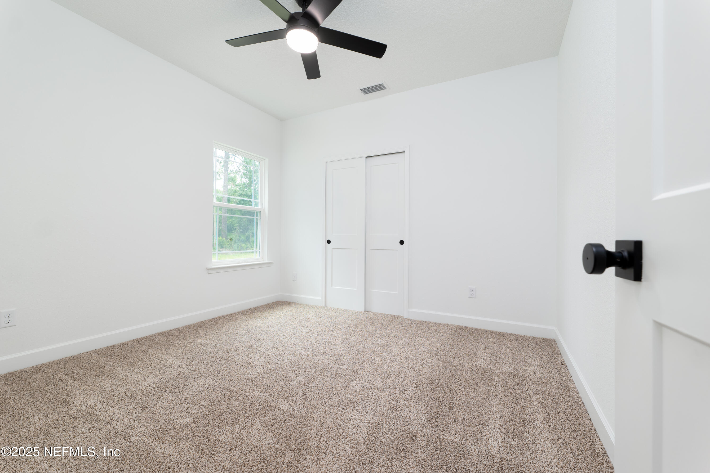 2482 Oleander Avenue Middleburg, FL 32068 - Photo 21 of 34 an empty room with windows and fan view