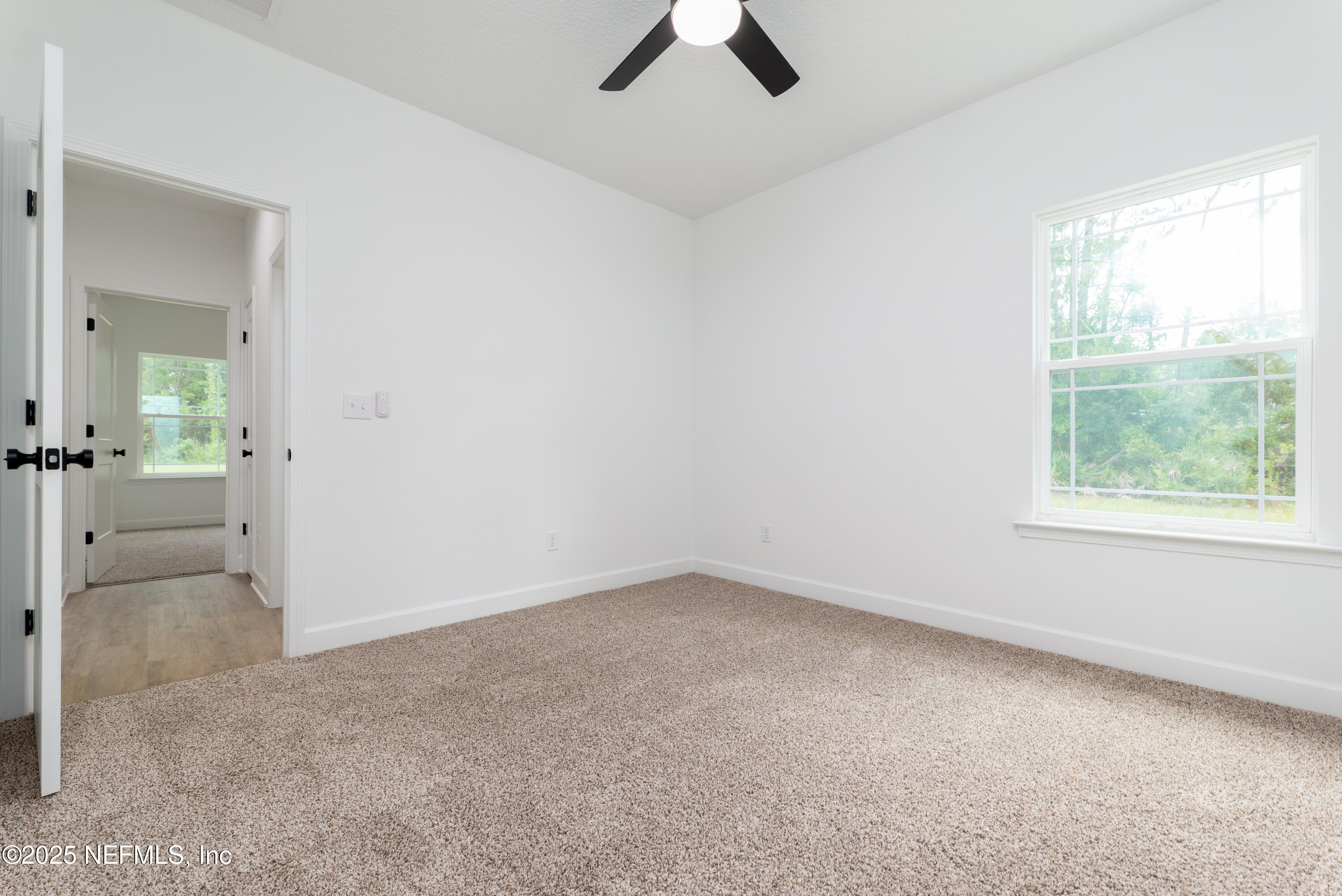 2482 Oleander Avenue Middleburg, FL 32068 - Photo 23 of 34 wooden floor in an empty room with a window