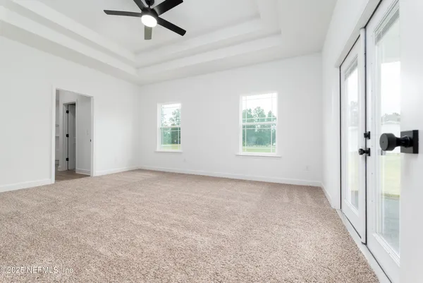 a view of a livingroom with a ceiling fan and window