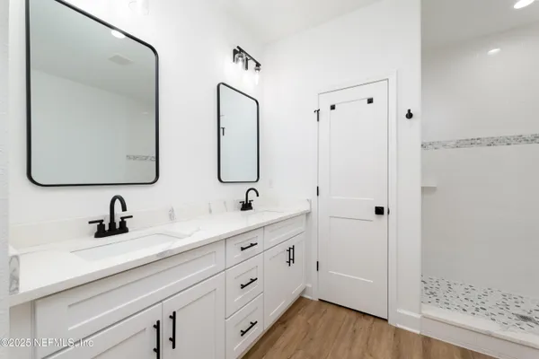 a bathroom with a double vanity sink mirror and
