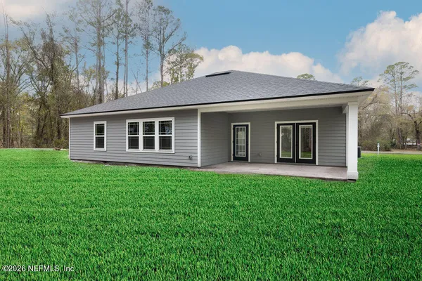 a view of a house with backyard porch and garden