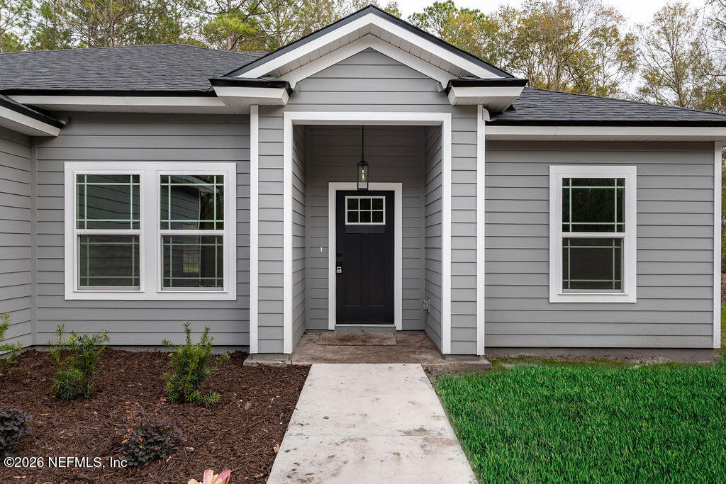 2482 Oleander Avenue Middleburg, FL 32068 - Photo 5 of 34 a front view of a house with garden