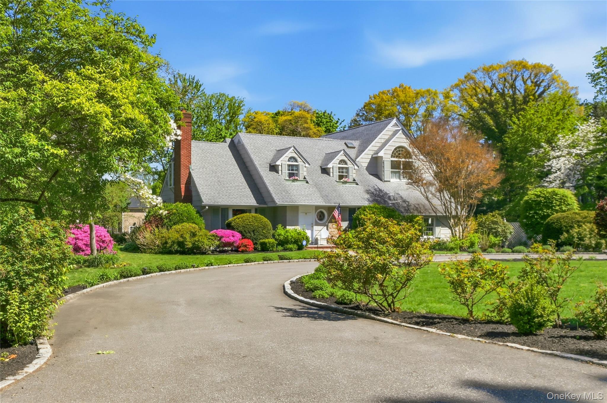 9 Townsend Road Glen Cove, NY 11542 - Photo 1 of 48 a front view of a house with a yard and garage