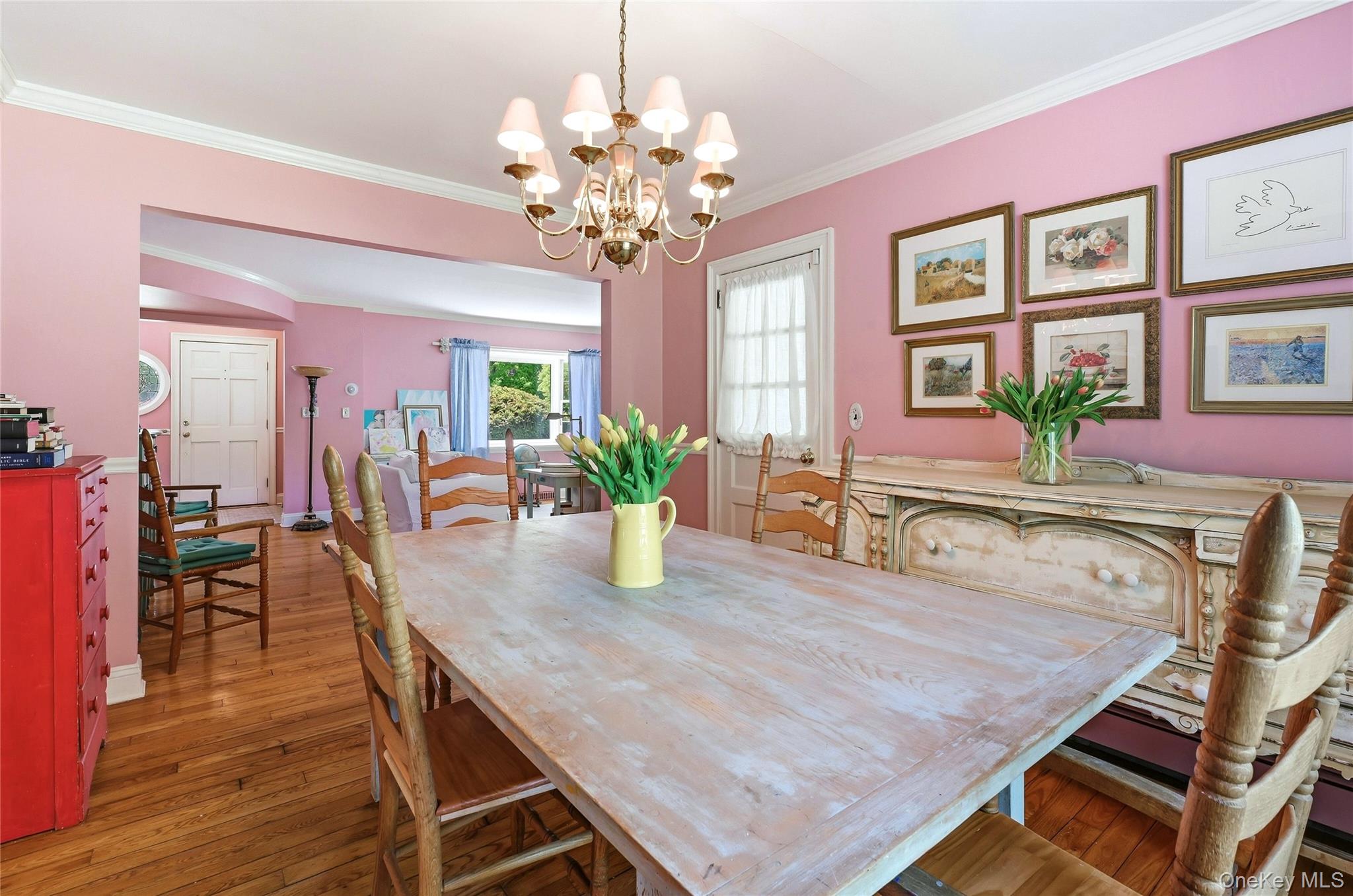 9 Townsend Road Glen Cove, NY 11542 - Photo 15 of 48 a dining room with wooden floor a chandelier a wooden table and chairs