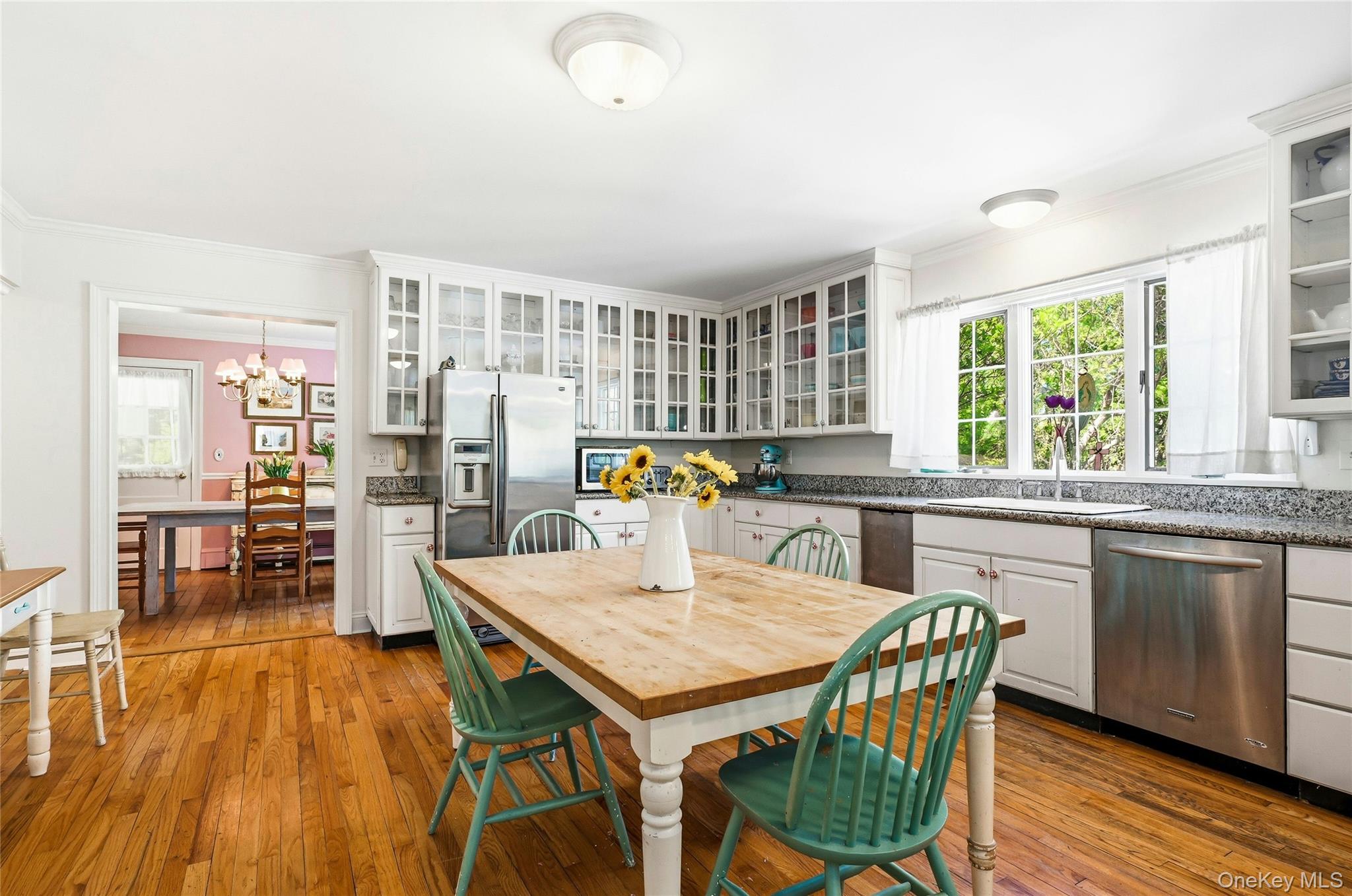 9 Townsend Road Glen Cove, NY 11542 - Photo 18 of 48 a kitchen with stainless steel appliances granite countertop a stove a refrigerator a kitchen island a table and chairs
