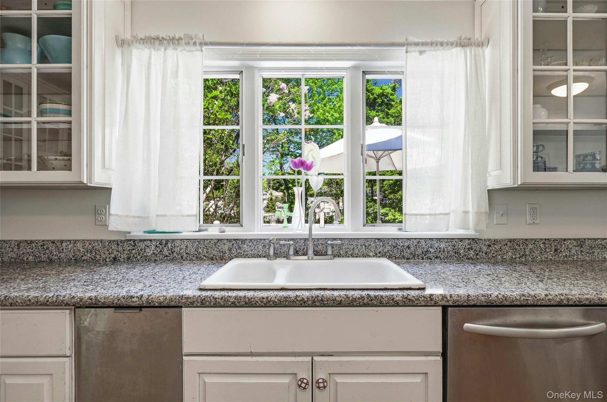 9 Townsend Road Glen Cove, NY 11542 - Photo 19 of 48 a kitchen with granite countertop a sink and a window