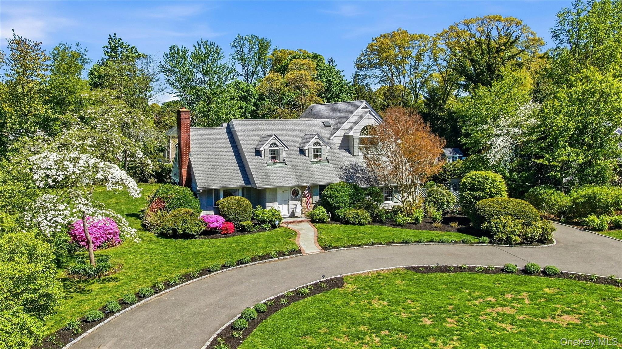 9 Townsend Road Glen Cove, NY 11542 - Photo 2 of 48 a front view of a house with a yard and fountain