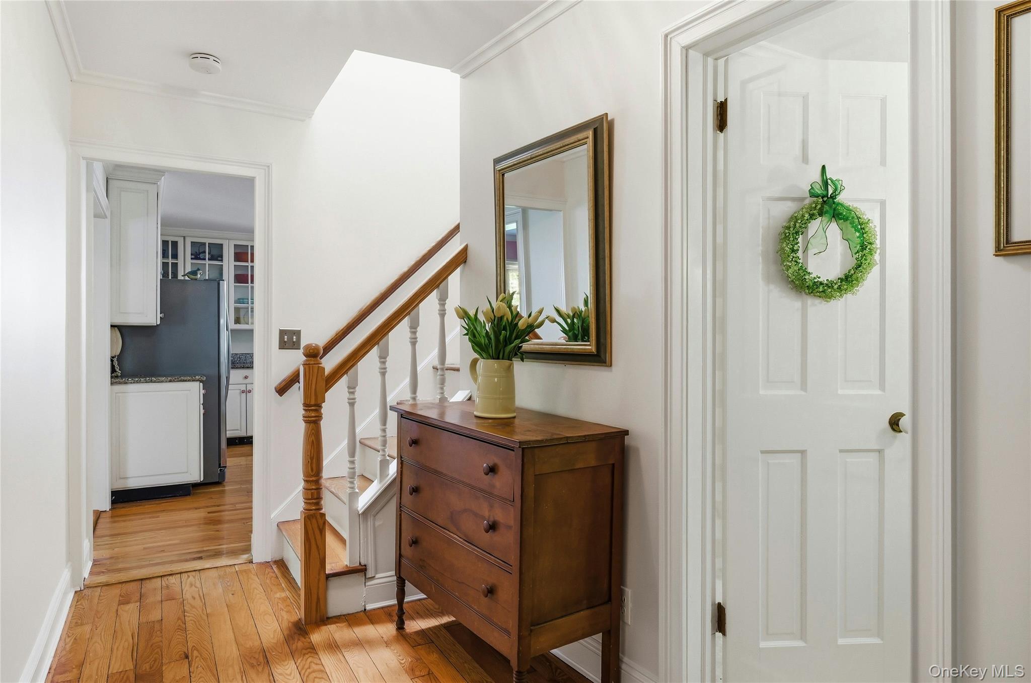9 Townsend Road Glen Cove, NY 11542 - Photo 26 of 48 a view of a hallway with wooden floor and staircase