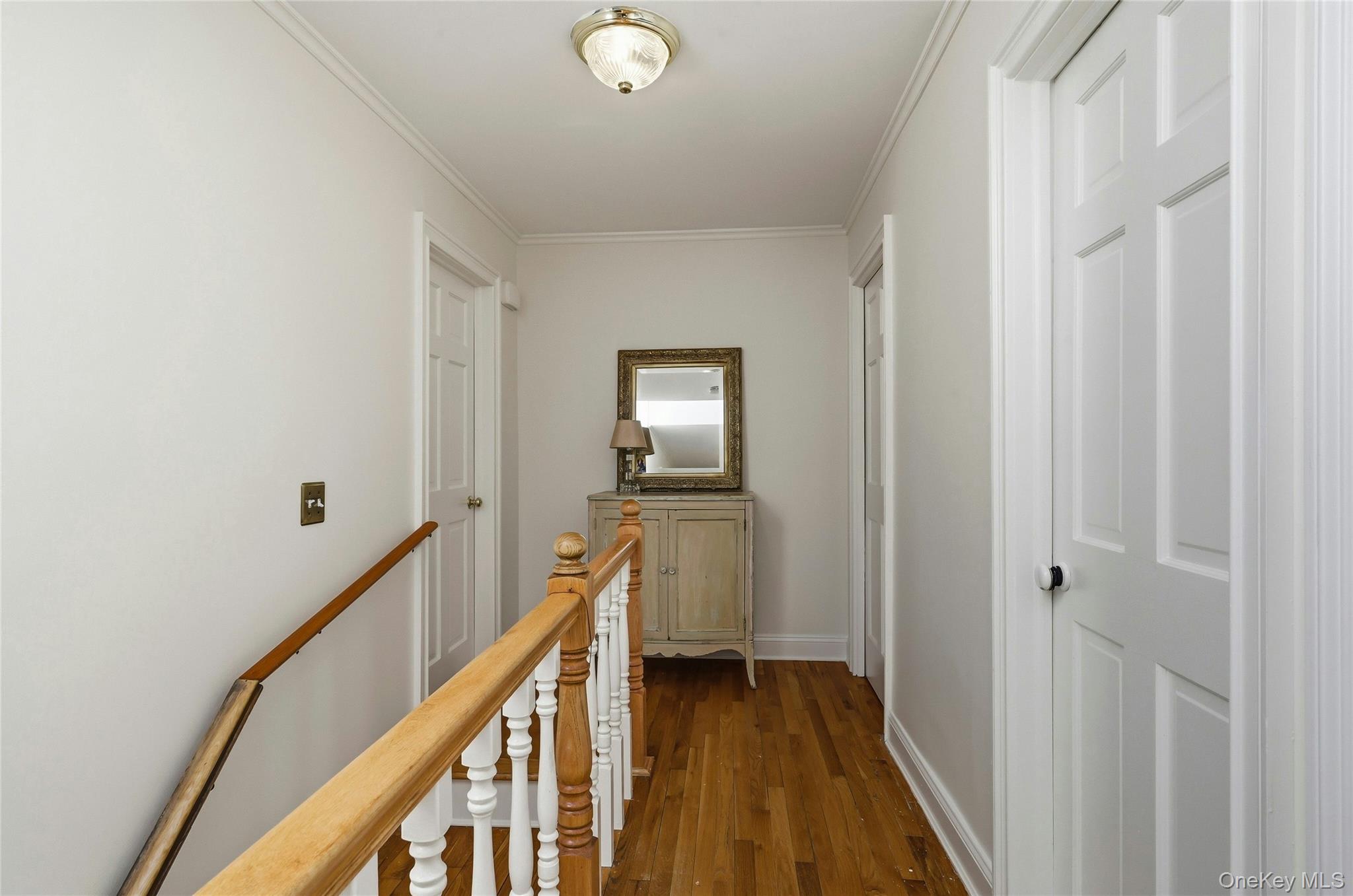 9 Townsend Road Glen Cove, NY 11542 - Photo 36 of 48 a view of a hallway with wooden floor and stairs
