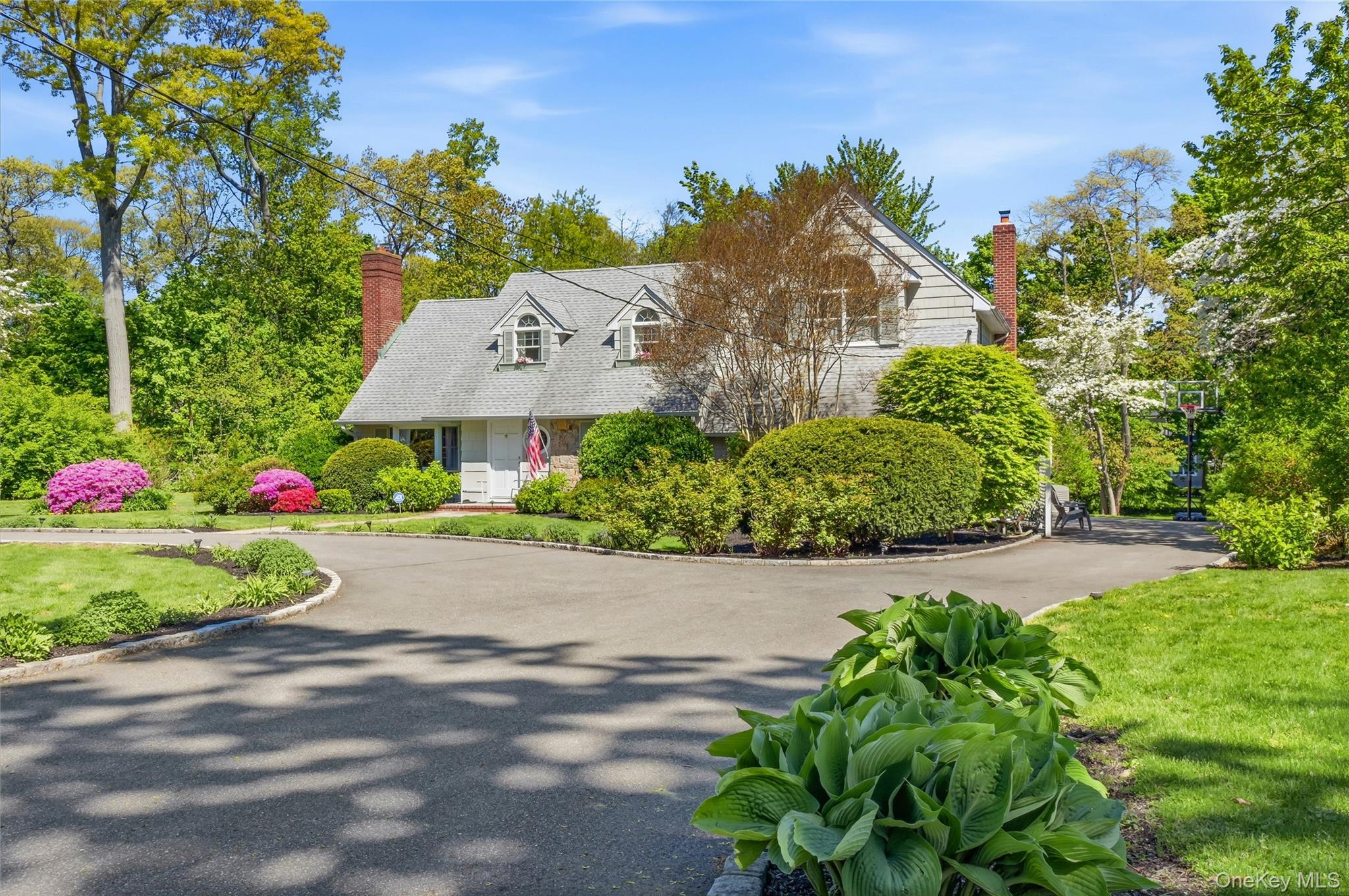 9 Townsend Road Glen Cove, NY 11542 - Photo 4 of 48 a front view of a house with a yard and fountain