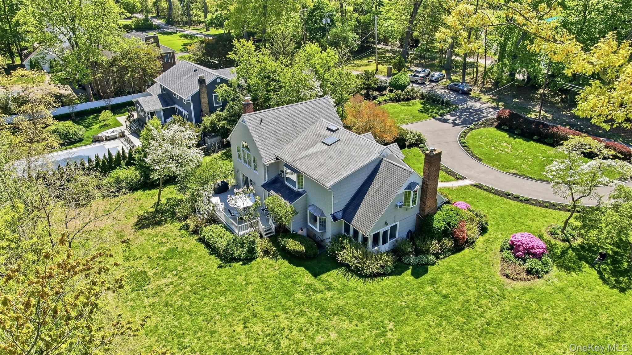 9 Townsend Road Glen Cove, NY 11542 - Photo 45 of 48 a view of a house with a yard and garden