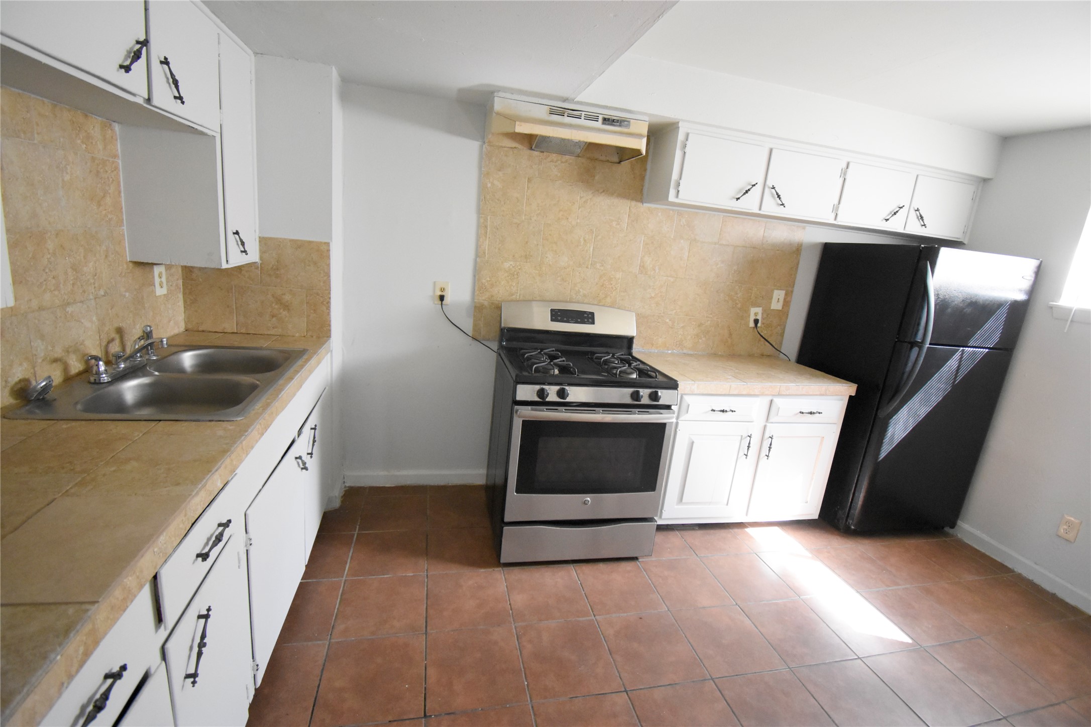 4353 Brinkley Street, Unit 5 Houston, TX 77051 - Photo 9 of 17 a kitchen with stainless steel appliances a stove a sink and a refrigerator