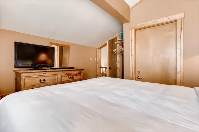 a bedroom with a bed and a flat screen tv