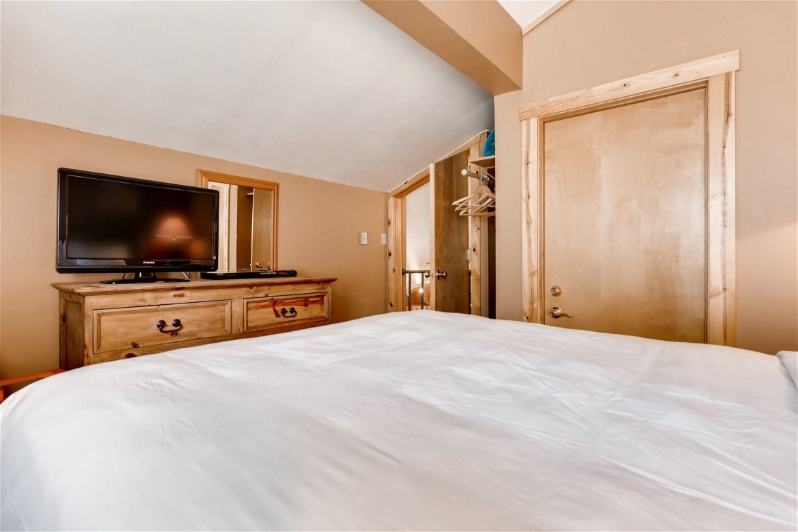 1937 Soda Ridge Road, Unit 1126 Keystone, CO 80435 - Photo 22 of 41 a bedroom with a bed and a flat screen tv
