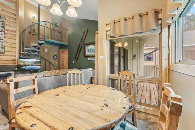 a bedroom with a bed a dresser and large mirror with wooden floor