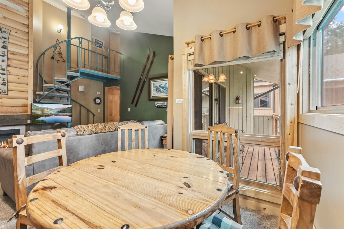 1937 Soda Ridge Road, Unit 1126 Keystone, CO 80435 - Photo 8 of 41 a bedroom with a bed a dresser and large mirror with wooden floor