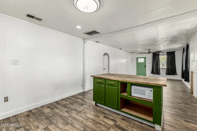 a view of living room with furniture and wooden floor