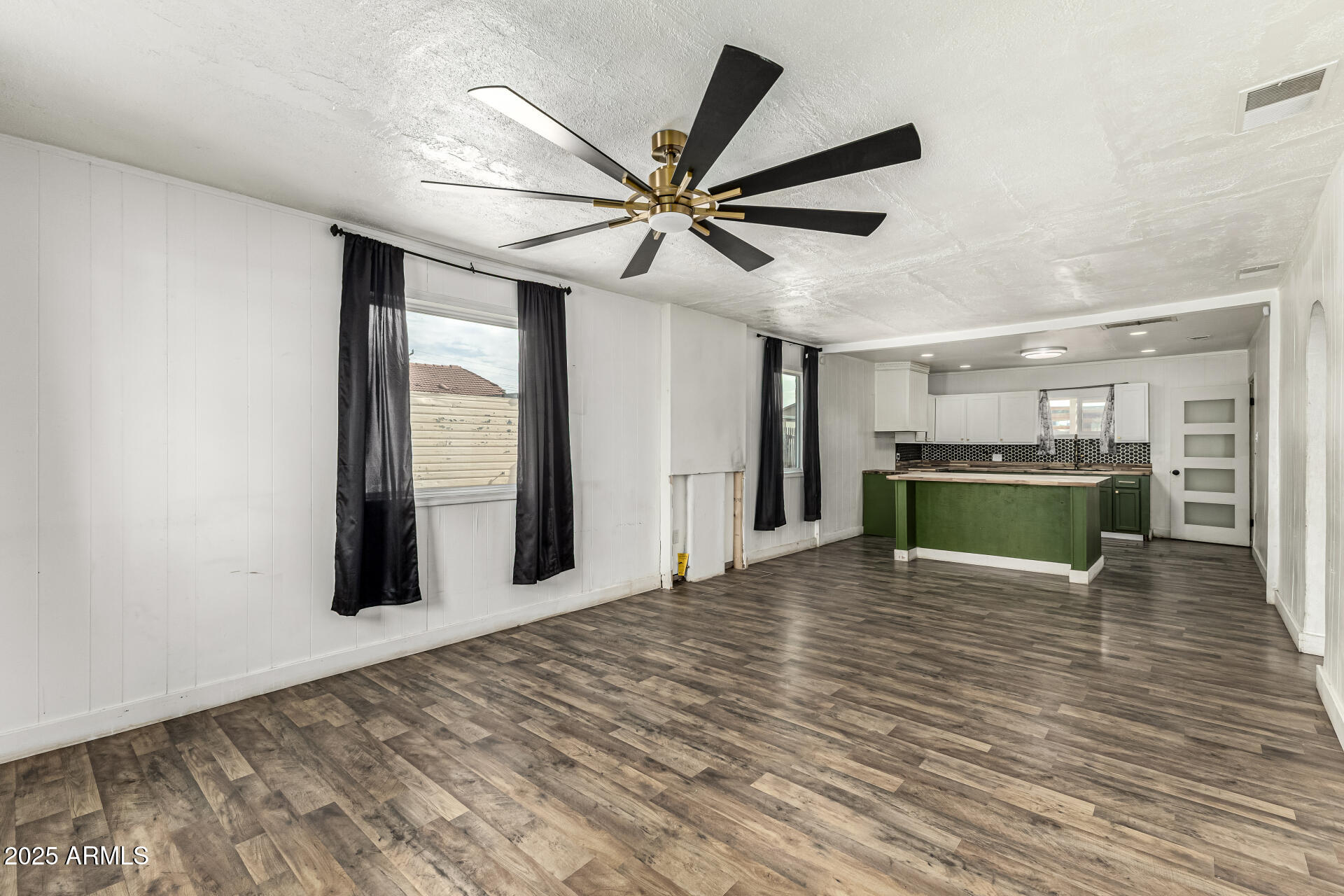2811 West Pima Street Phoenix, AZ 85009 - Photo 6 of 24 a view of a livingroom with a ceiling fan hardwood floor and a ceiling fan