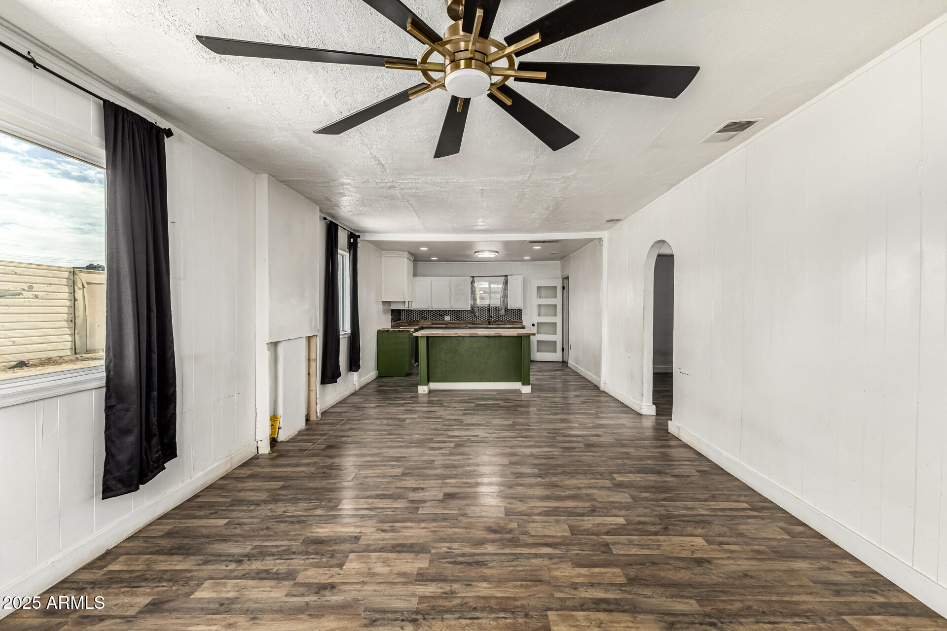 2811 West Pima Street Phoenix, AZ 85009 - Photo 7 of 24 a view of a livingroom with a ceiling fan and wooden floor