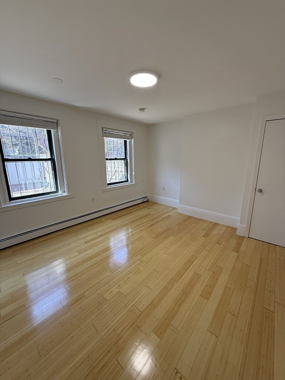 4 Milford Street, Unit M02 Boston, MA 02118 - Photo 1 of 9 a view of empty room with wooden floor and fan