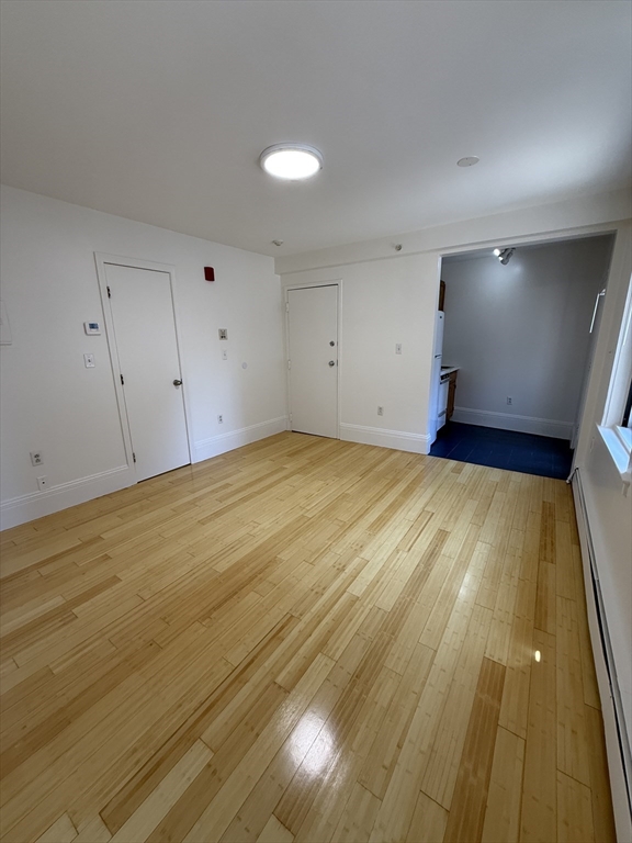 4 Milford Street, Unit M02 Boston, MA 02118 - Photo 3 of 9 a view of an empty room with wooden floor