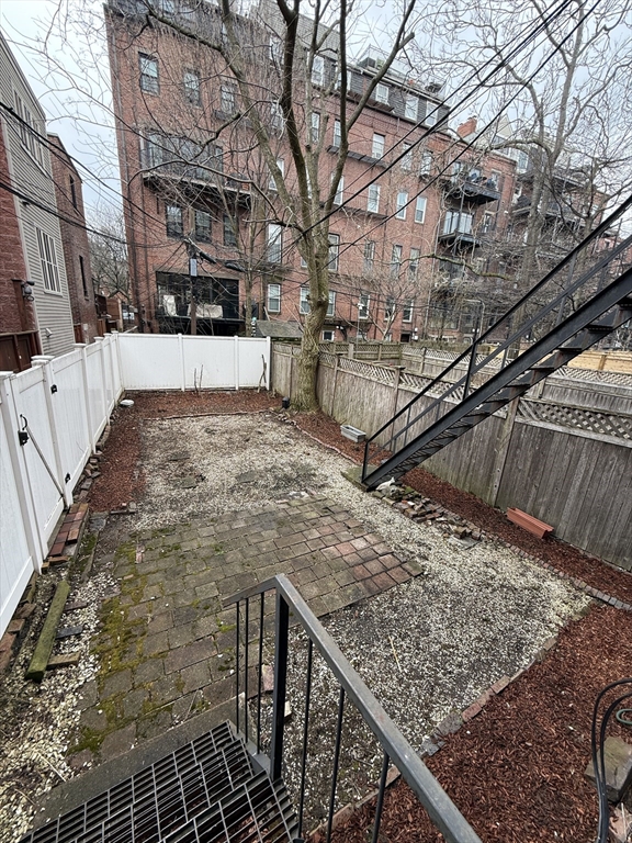 4 Milford Street, Unit M02 Boston, MA 02118 - Photo 4 of 9 a view of a backyard with wooden fence