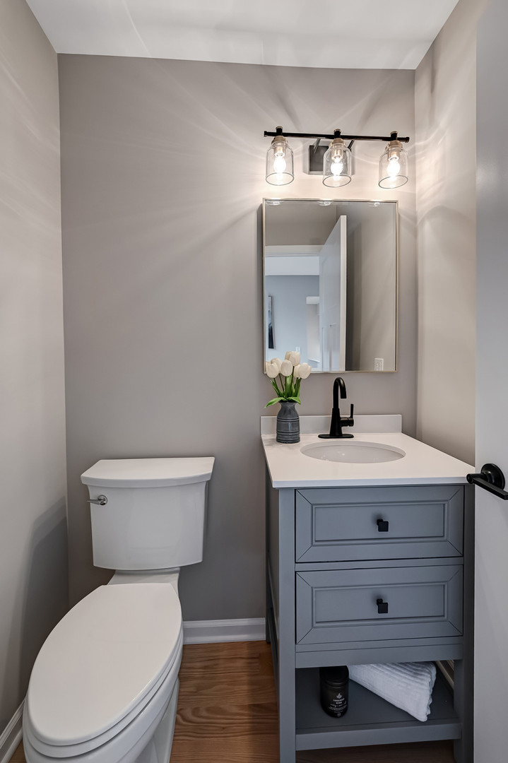 27 Windward Circle Willowbrook, IL 60527 - Photo 13 of 35 a bathroom with a toilet a sink a vanity and mirror