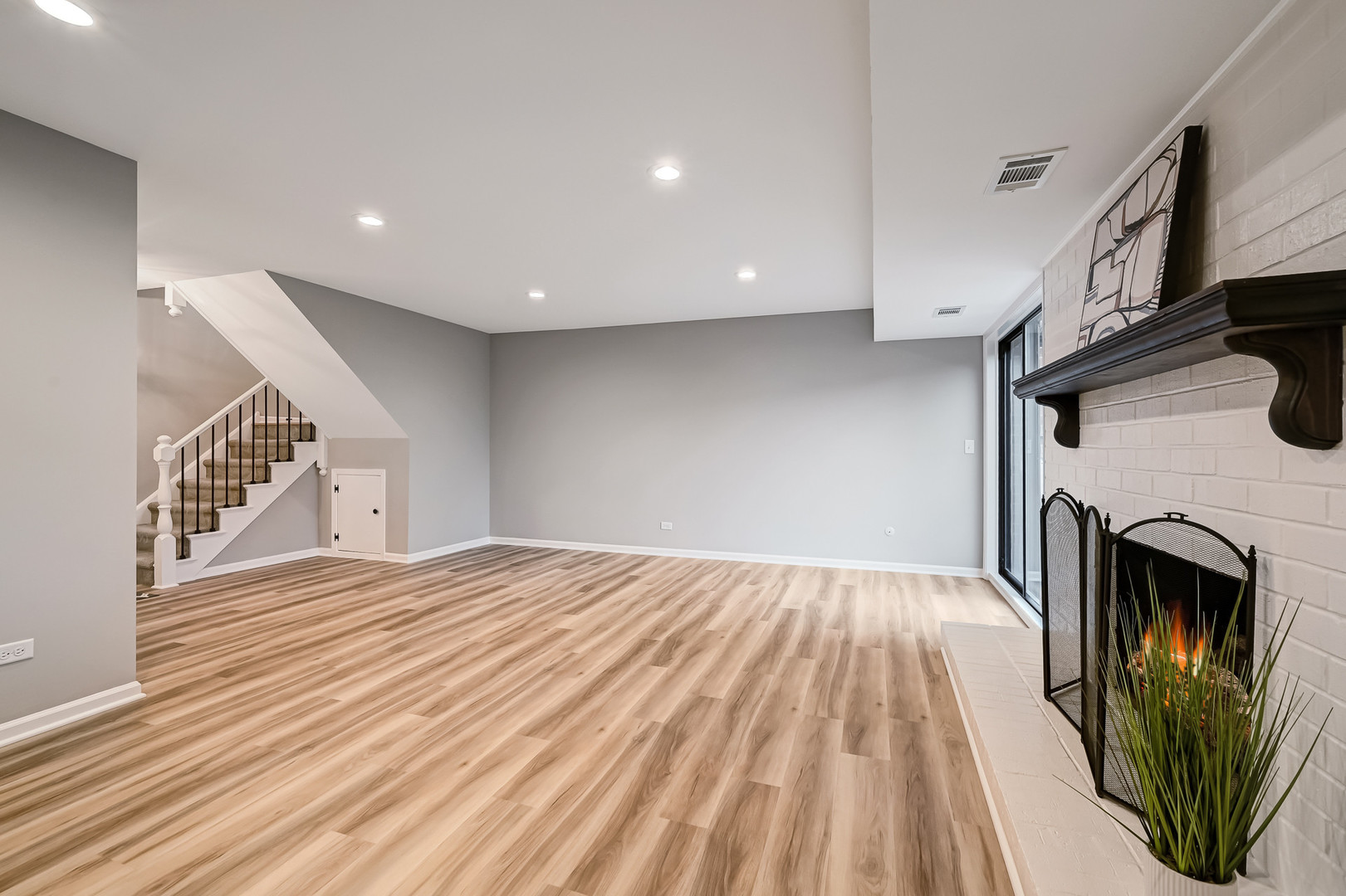27 Windward Circle Willowbrook, IL 60527 - Photo 21 of 35 a view of an empty room with wooden floor fireplace and a window