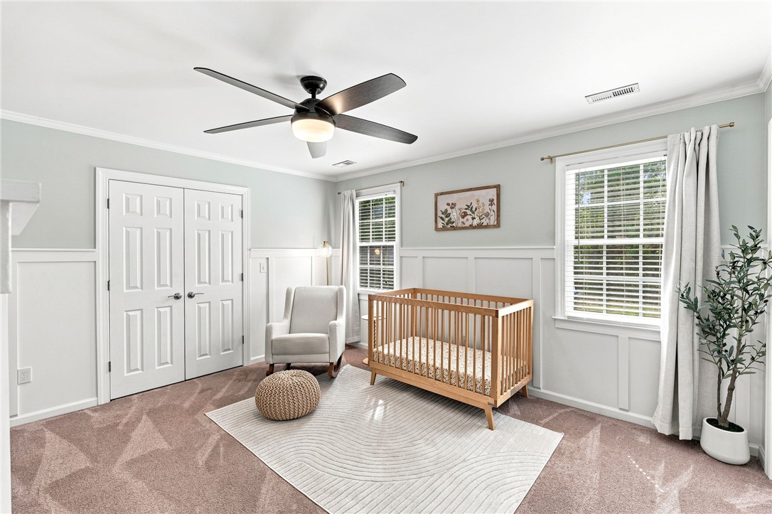 320 Watson Road Easley, SC 29642 - Photo 30 of 50 Classic wainscoting and plush carpeting create a cozy atmosphere in this charming bedroom.