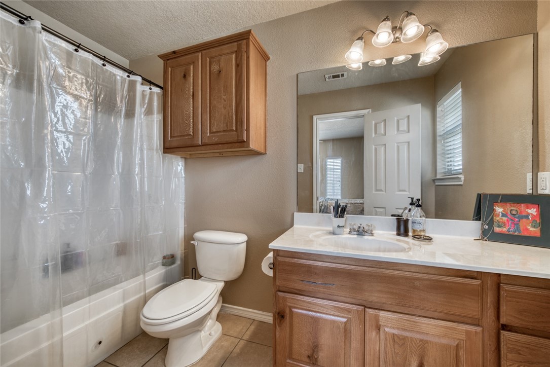 2327 Autumn Chase Loop College Station, TX 77840 - Photo 11 of 12 a bathroom with a sink a toilet and shower