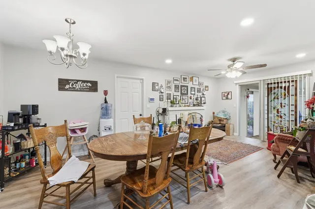 a view of a dining room with furniture and chandelier