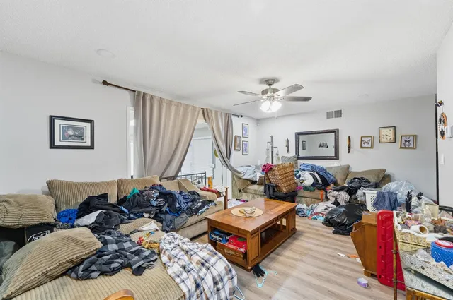 a living room with lots of furniture and a wooden floor