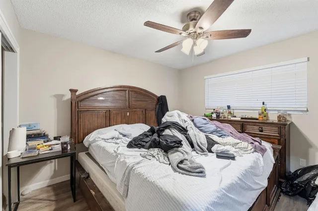 a bedroom with a bed and a chandelier