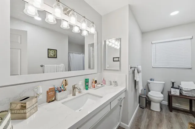 a bathroom with a sink vanity granite and a mirror
