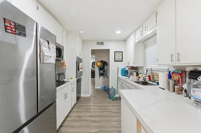 a kitchen view with stainless steel appliances lots of counter top space