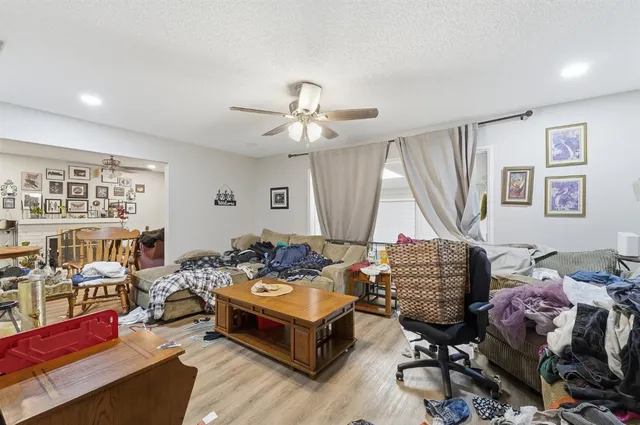 a living room with furniture a rug and a chandelier