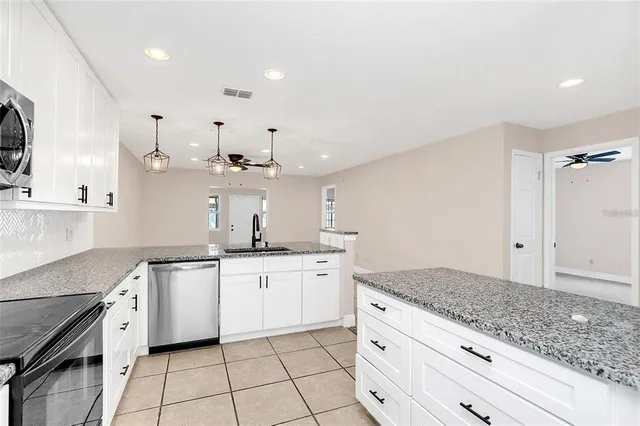 a kitchen with a sink stove and cabinets