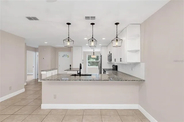 a view of kitchen with windows and refrigerator