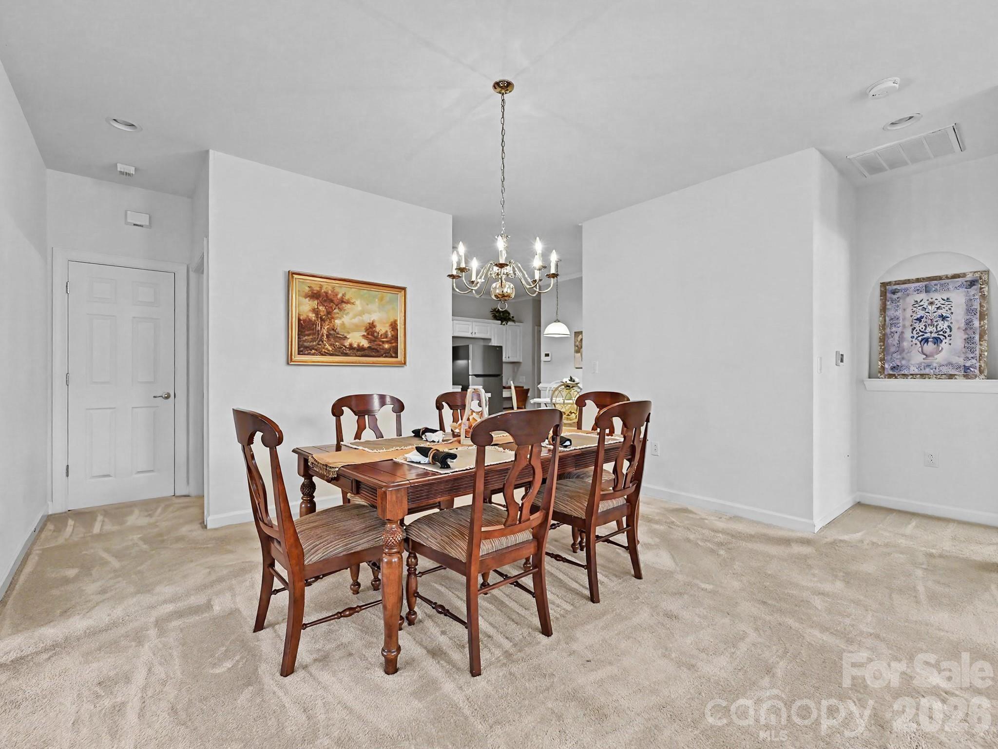 8655 Windsor Ridge Drive Charlotte, NC 28277 - Photo 13 of 22 a view of a dining room with furniture and chandelier