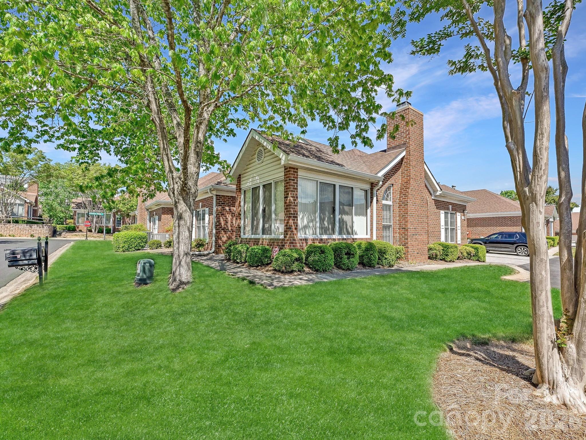 8655 Windsor Ridge Drive Charlotte, NC 28277 - Photo 2 of 22 a front view of a house with a yard and trees
