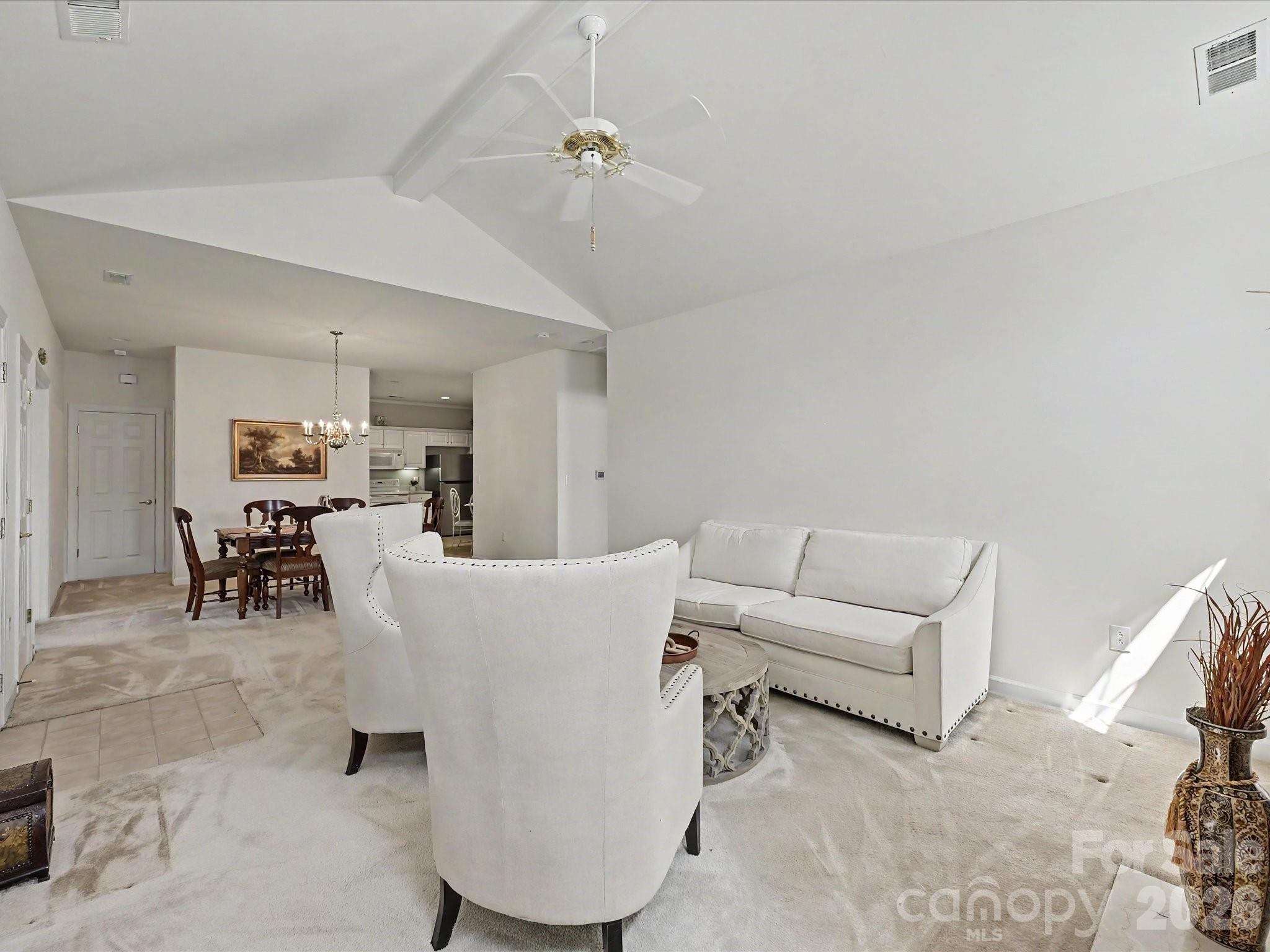 8655 Windsor Ridge Drive Charlotte, NC 28277 - Photo 6 of 22 a living room with furniture and a dining table with kitchen view