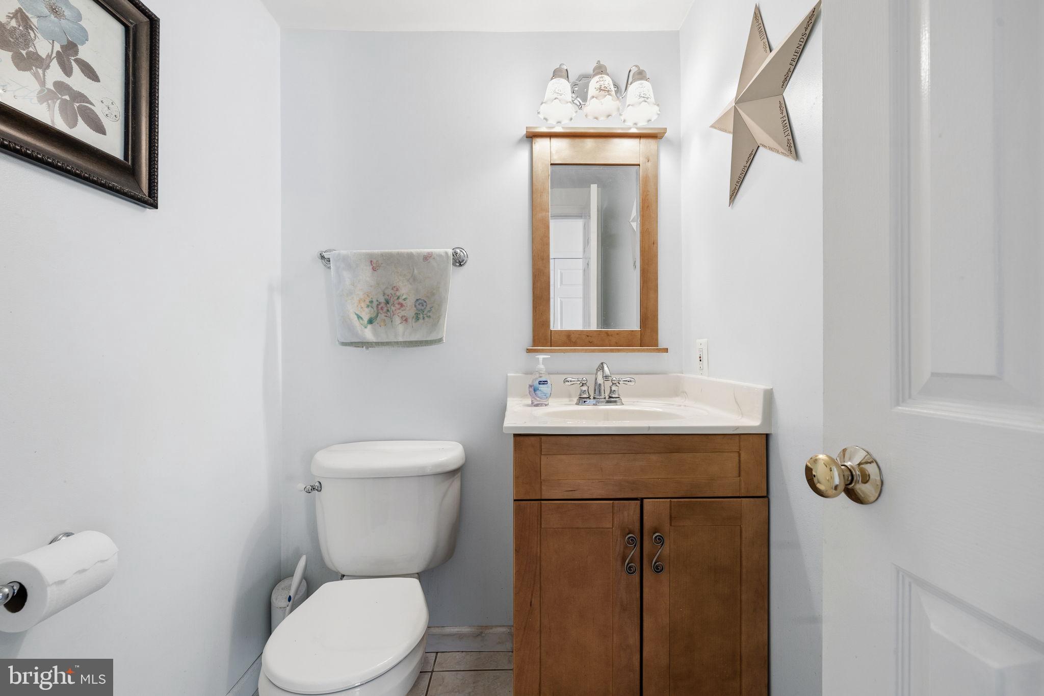 4357 Cub Run Road Chantilly, VA 20151 - Photo 16 of 40 a bathroom with a toilet sink vanity and mirror