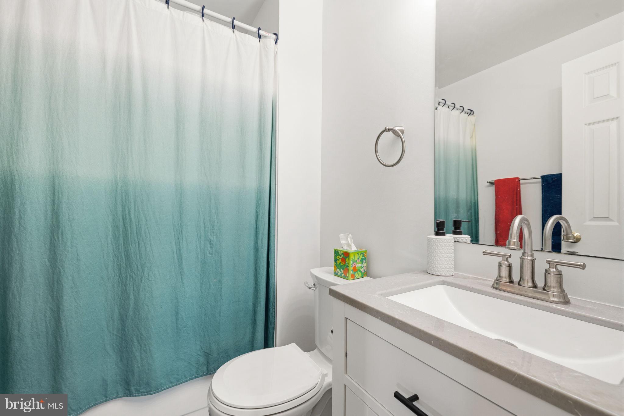 4357 Cub Run Road Chantilly, VA 20151 - Photo 23 of 40 a bathroom with a granite countertop sink vanity mirror and toilet