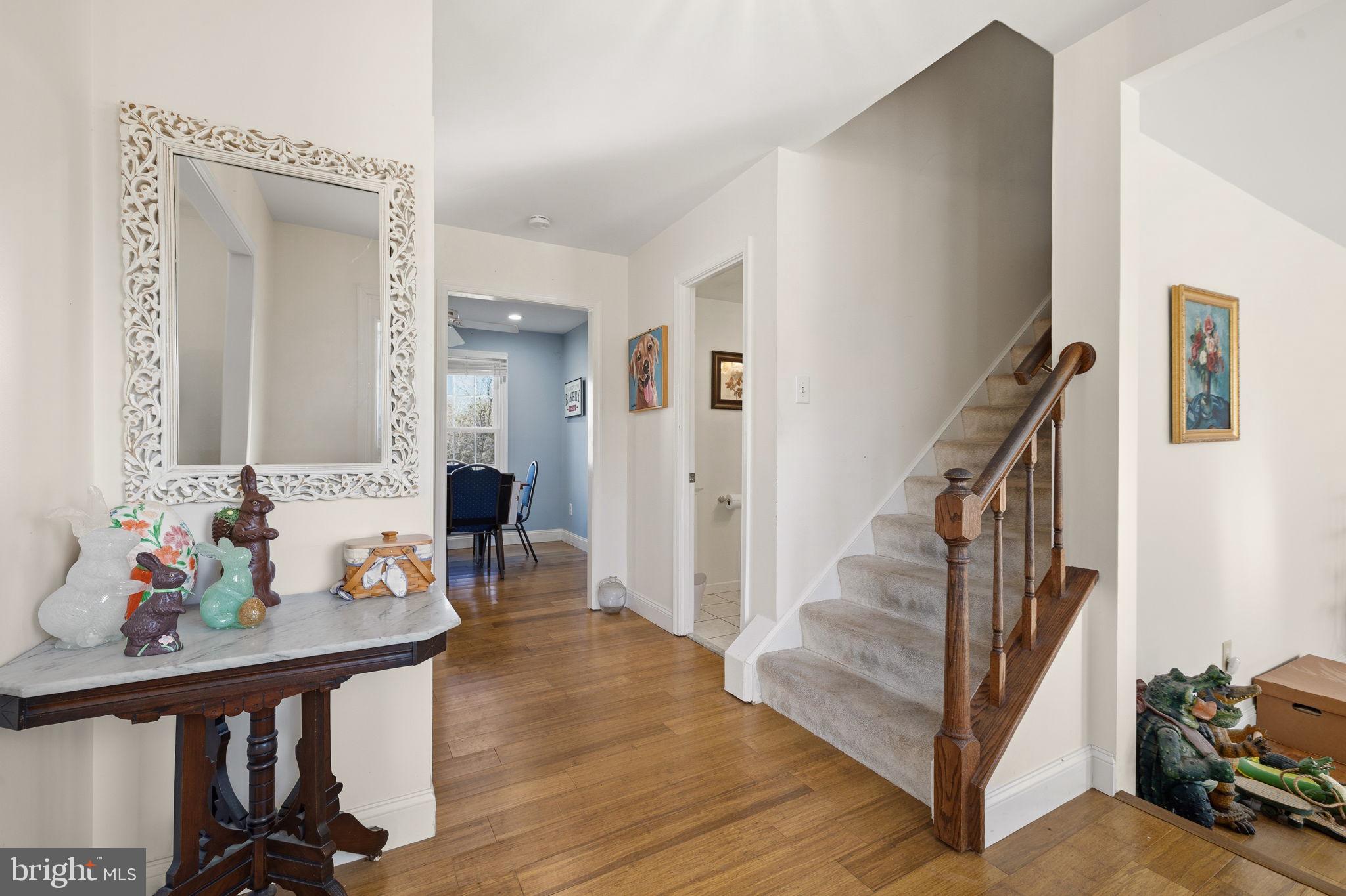 4357 Cub Run Road Chantilly, VA 20151 - Photo 5 of 40 a view of a hallway to a livingroom with wooden floor and furniture