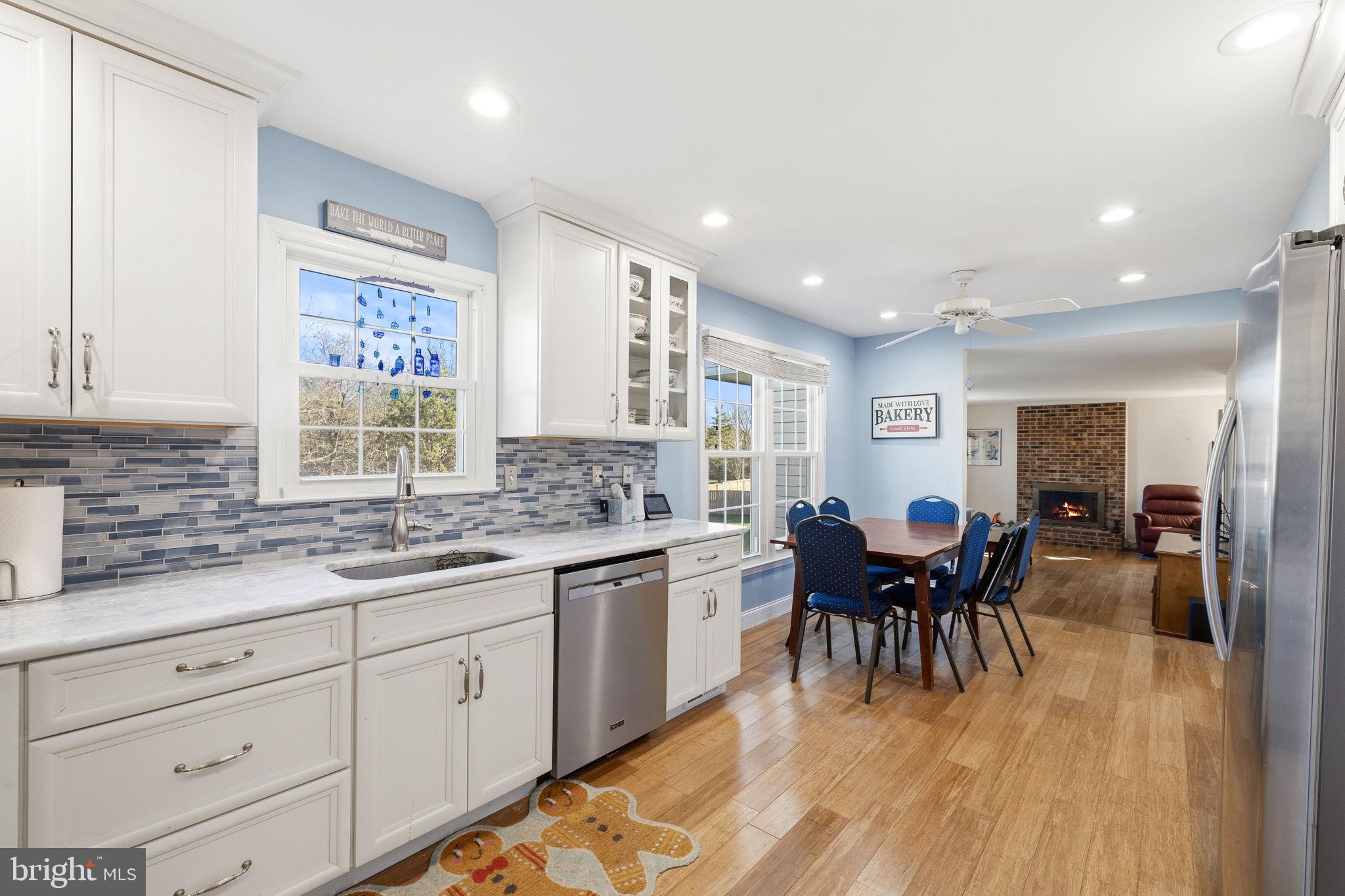4357 Cub Run Road Chantilly, VA 20151 - Photo 8 of 40 a kitchen with a dining table chairs and white appliances