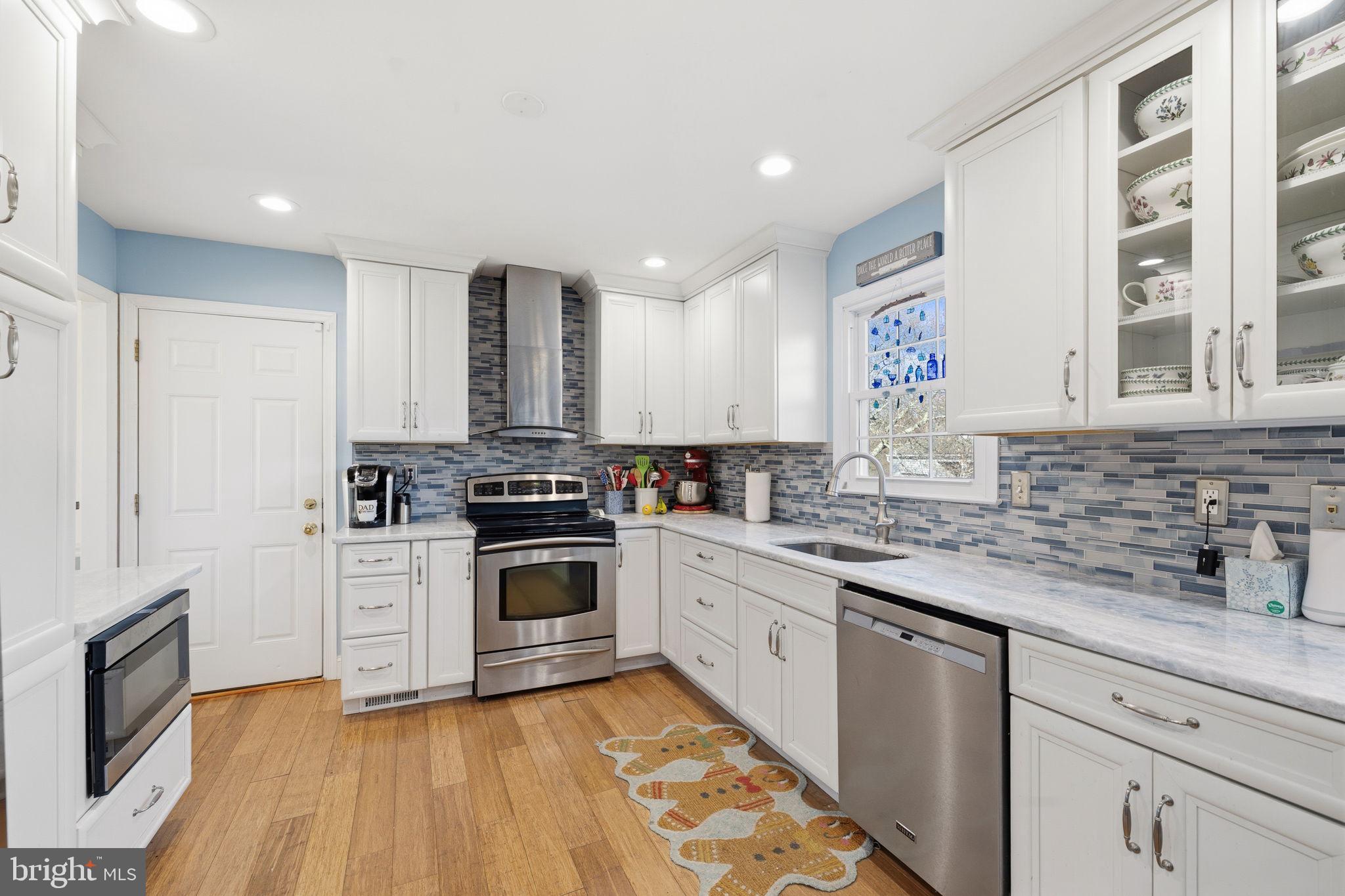 4357 Cub Run Road Chantilly, VA 20151 - Photo 9 of 40 a kitchen with stainless steel appliances granite countertop a stove and a sink