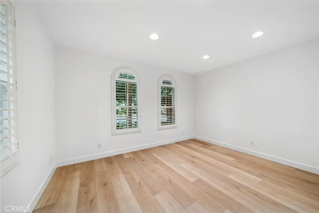 wooden floor in a room next to a window