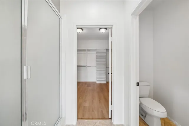 a bathroom with a granite countertop toilet a sink and mirror