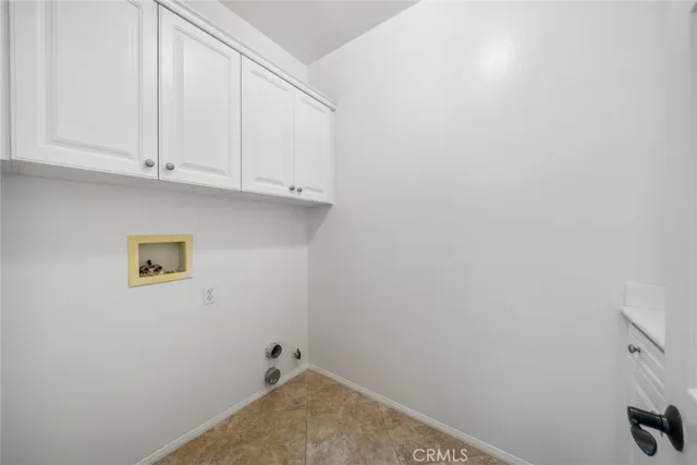 a view of a room with white cabinets